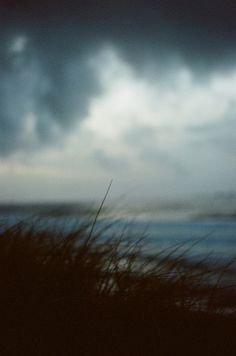 black and white photograph of clouds over the ocean