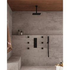 a bathroom with concrete walls and flooring, including a walk in shower head mounted on the wall