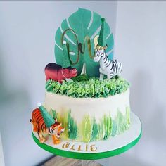 there is a cake decorated with zebras and other animals on top of the cake