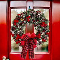 a red door with a christmas wreath on it