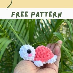 a hand holding a small crocheted animal with the words free pattern on it