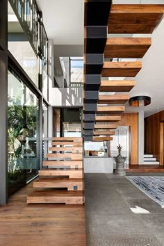 an open floor plan with wooden stairs leading to the upper level