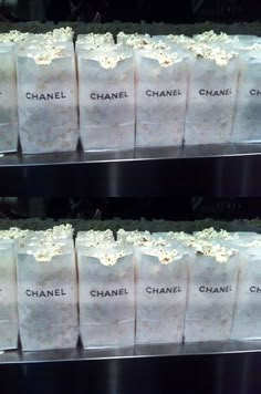 several bags of chanel popcorn are stacked on top of each other