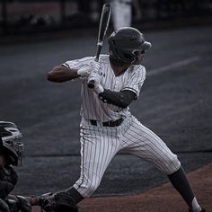 a baseball player holding a bat next to home plate