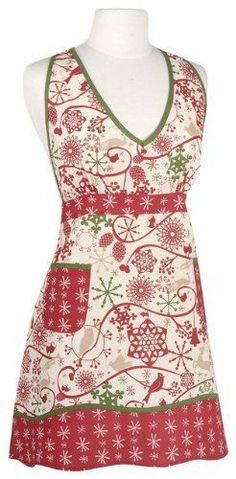 a white mannequin wearing an apron with red and green designs on the front