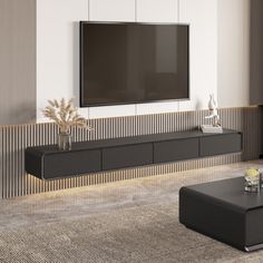 a large flat screen tv mounted to the side of a wall in a living room