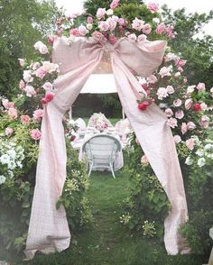 an outdoor wedding ceremony set up with pink flowers