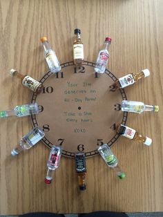 a clock made out of liquor bottles on top of a wooden table with words written in it