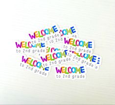 some stickers that say welcome to 2nd grade