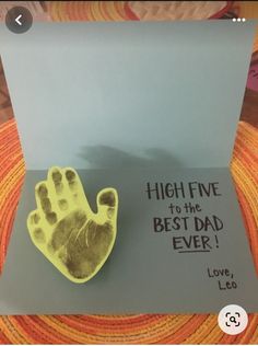 a brooch that is on top of a card with the words high five to the best dad ever