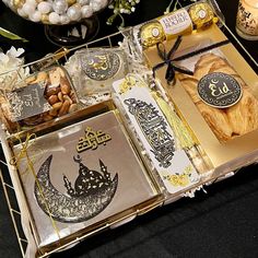 an open box filled with assorted items on top of a black cloth covered table