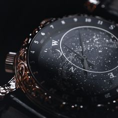 a close up shot of a watch with stars on the dial