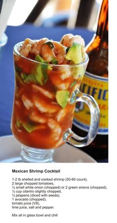 a glass filled with food next to a bottle