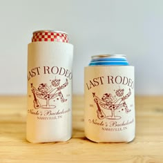 two can coolers sitting on top of a wooden table