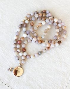 Our Grounding Mala Pendant Necklace is handmade using beautiful Australian Agate gemstones and a 14k gold fill Daisy pendant. Enjoy free shipping in North America. Wild Daisies, Intention Bracelets, Mala Jewelry, Daisy Pendant, Coastal City, Mala Bead Necklace, Mala Bracelet, Mala Necklace, Velvet Bag