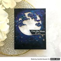 a card with the words over the moon written on it and flowers in the background