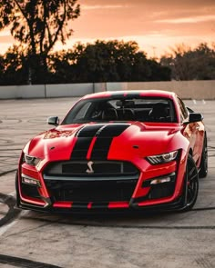 a red and black sports car parked in a parking lot