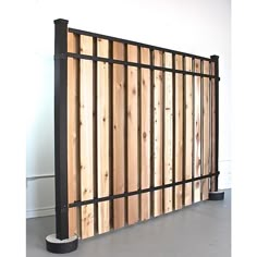 a wall made out of wooden boards and metal bars in an empty room with white walls