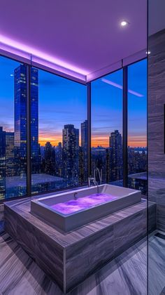 a bathroom with a large jacuzzi tub in the middle of it and city view