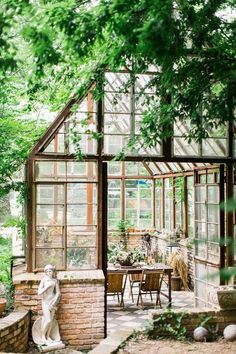 a glass house with an outdoor dining area