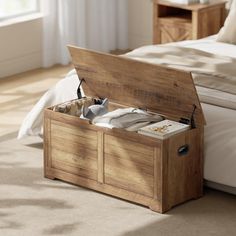 an open wooden box sitting on top of a bed