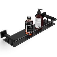 two bottles of soap and lotion on a black metal shelf against a white background