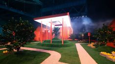 an outdoor stage set up for a show with oranges and trees in the background