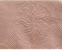 a quilt with an eye design on the front and back side, in light pink