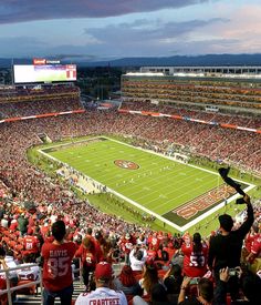 a football stadium filled with people watching the game