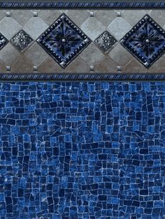 an image of a blue tile wall with different designs on it's sides and the floor