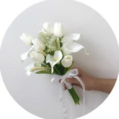 a person holding a bouquet of white flowers