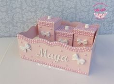 a pink toy castle with white bows and name maya