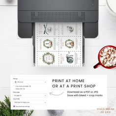 a printer sitting on top of a desk next to a cup of coffee and other items