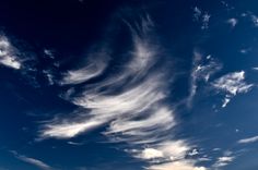 the sky is filled with white clouds and blue water