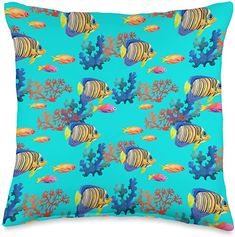 a blue pillow with an image of fish and corals on the bottom, in front of a white background