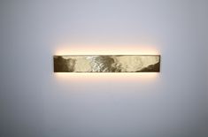 a wall mounted light in a white room