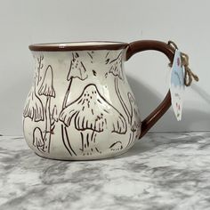 a white and brown mug sitting on top of a counter