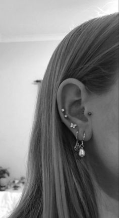 black and white photograph of woman with ear piercings