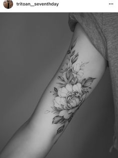 a woman's arm with flowers on it