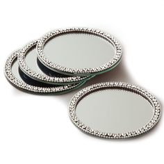 three round mirrors with crystal trim on them