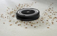 a roomba is laying on the floor with lots of dirt around it