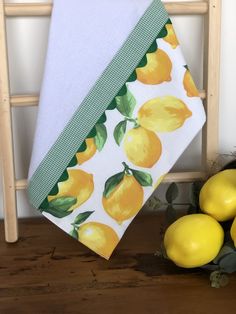 two lemons are on the table next to some towels