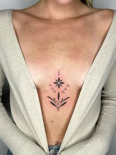 a woman's chest with a flower tattoo on her left side ribcage