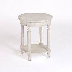 a small white table with one shelf on the side