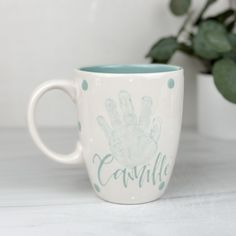 a coffee cup with a hand print on it