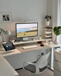 a desk with a computer monitor, keyboard and mouse on top of it in front of a window