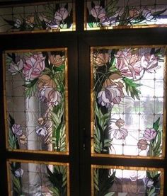 two stained glass windows with flowers on them