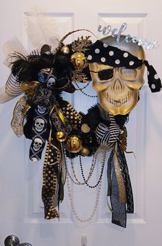 a door decorated with black and gold decorations, skull masks and pearls on it's side