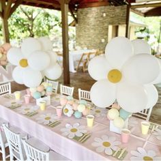 the tables are decorated with white balloons and flowers