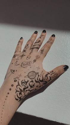 a person's hand with tattoos on it